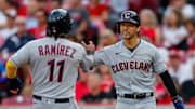 Aug 15, 2023; Cincinnati, Ohio, USA; Cleveland Guardians left fielder Steven Kwan (38) high fives third baseman Jose Ramirez (11) after scoring on a two-run single hit by first baseman Kole Calhoun (not pictured) in the first inning against the Cincinnati Reds at Great American Ball Park. Mandatory Credit: Katie Stratman-Imagn Images