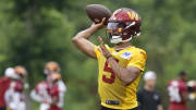 Jun 5, 2024; Ashburn, VA, USA; Washington Commanders quarterback Jayden Daniels (5) passes a ball during an OTA workout at Commanders Park. Mandatory Credit: Geoff Burke-USA TODAY Sports