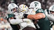 Michigan State defensive lineman Jalen Thompson (9), left, and defensive lineman Alex VanSumeren (91) tackle Western Michigan running back Jalen Buckley (6) for a safety during the second half at Spartan Stadium in East Lansing on Friday, August 29, 2025.