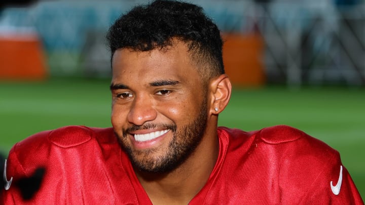 Jul 29, 2024; Miami Gardens, FL, USA; Miami Dolphins quarterback Tua Tagovailoa (1) reacts while talking to reporters during an interview after training camp at Baptist Health Training Complex.