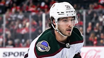 Apr 14, 2024; Calgary, Alberta, CAN; Arizona Coyotes defenseman Sean Durzi (50) in action against the Calgary Flames during the first period at Scotiabank Saddledome. Mandatory Credit: Brett Holmes-Imagn Images