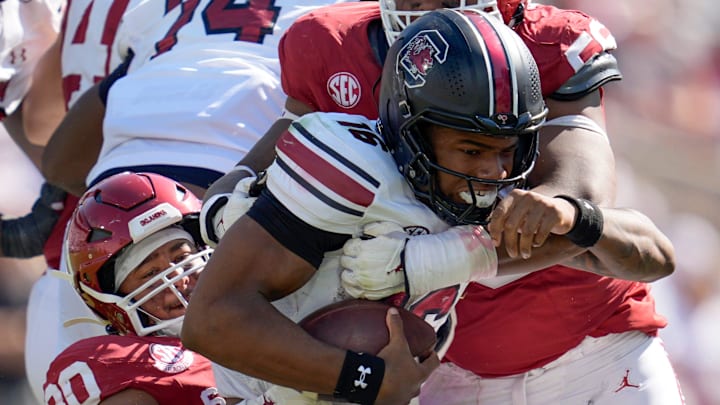 Oklahoma Sooners defensive lineman Trace Ford (30) and Oklahoma Sooners defensive lineman Gracen Halton (56) bring down South Carolina Gamecocks quarterback LaNorris Sellers (16) during a college football game between the University of Oklahoma Sooners (OU) and the South Carolina Gamecocks at Gaylord Family - Oklahoma Memorial Stadium in Norman, Okla., Saturday, Oct. 19, 2024.