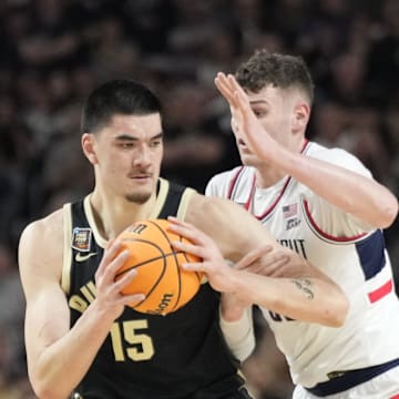 Purdue Boilermakers center Zach Edey (15) is guarded by Connecticut Huskies center Donovan Clingan (32) during the Men's NCAA national championship game at State Farm Stadium in Glendale on April 8, 2024.