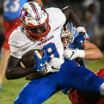 Riverside's Mikkel Skinner (8) is tackled by JL Mann's Jackson Surkamer (42) during a game against Riverside High School that resulted in a 45-14 win for the Patriots on Friday, August 25, 2023.