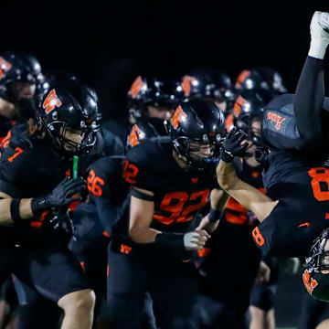 West De Pere High School's Judeah Kniskern (8) does a backflip as the Phantoms are introduced as a team before a WIAA Division 2 state semifinal against Rice Lake High School on Friday, November 15, 2024, at Marshfield High School in Marshfield, Wis. Rice Lake won the game, 31-24, after forcing a West De Pere turnover on downs inside the five-yard line in the final minute of the game