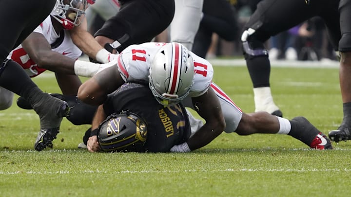 Nov 16, 2024; Chicago, Illinois, USA; Ohio State Buckeyes linebacker C.J. Hicks (11) sacks Northwestern Wildcats quarterback Jack Lausch (12)  during the second half at Wrigley Field. Mandatory Credit: David Banks-Imagn Images