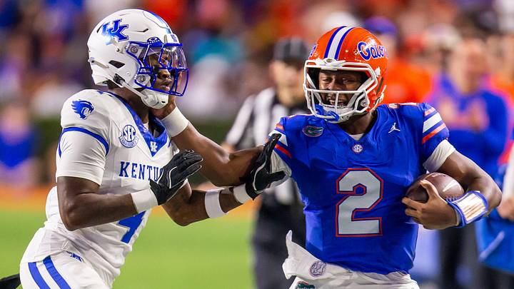 Florida Gators quarterback DJ Lagway (2) stiff arms Kentucky Wildcats defensive back Kristian Story (4) during the first half at Ben Hill Griffin Stadium in Gainesville, FL on Saturday, October 19, 2024 against the Kentucky Wildcats. [Doug Engle/Gainesville Sun]