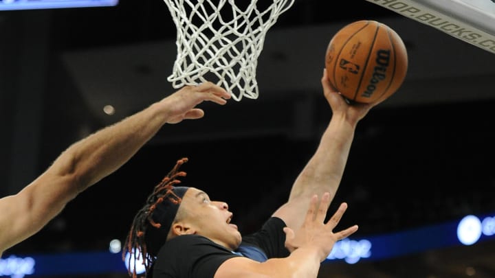 Oct 1, 2022; Milwaukee, Wisconsin, USA; Memphis Grizzlies forward Kenny Lofton Jr. (6) puts up a shot against Milwaukee Bucks center Brook Lopez (11) in the first half at Fiserv Forum. Mandatory Credit: Michael McLoone-USA TODAY Sports