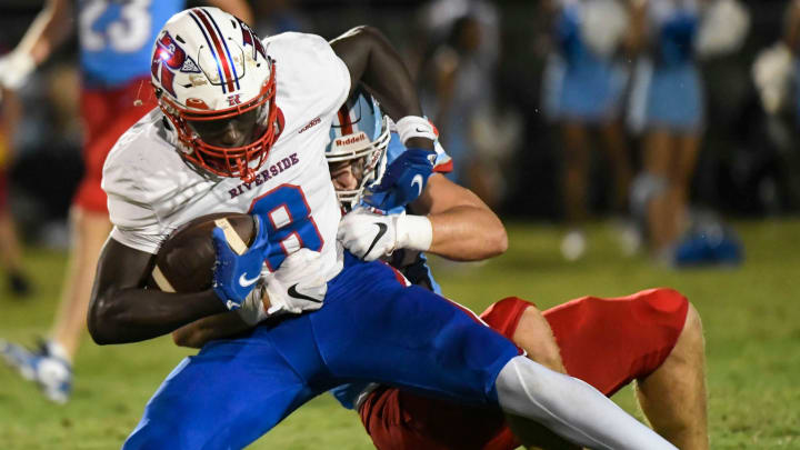 Riverside's Mikkel Skinner (8) is tackled by JL Mann's Jackson Surkamer (42) during a game against Riverside High School that resulted in a 45-14 win for the Patriots on Friday, August 25, 2023.