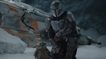 The Mandalorian (Pedro Pascal) and the Child in THE MANDALORIAN, season two. © 2020 Lucasfilm Ltd. & TM. All Rights Reserved.