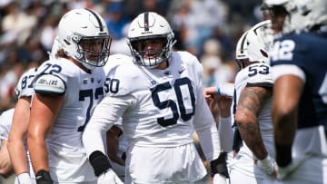 Penn State offensive linemen Nolan Rucci (72) and Cooper Cousins (50) talk before a play during the Blue-White game at Beaver Stadium on Saturday, April 13, 2024, in State College.