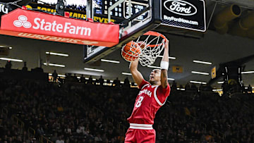 Jan 11, 2025; Iowa City, Iowa, USA; Indiana Hoosiers forward Bryson Tucker (8) dunks as guard Myles Rice (1) and Iowa Hawkeyes guard Drew Thelwell (3) look on during the first half at Carver-Hawkeye Arena. Mandatory Credit: Jeffrey Becker-Imagn Images