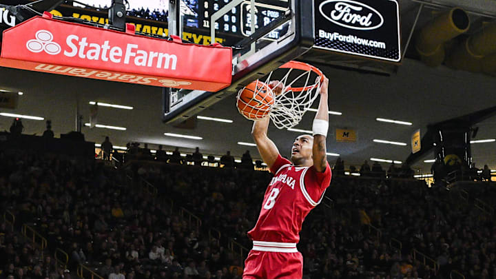 Jan 11, 2025; Iowa City, Iowa, USA; Indiana Hoosiers forward Bryson Tucker (8) dunks as guard Myles Rice (1) and Iowa Hawkeyes guard Drew Thelwell (3) look on during the first half at Carver-Hawkeye Arena. Mandatory Credit: Jeffrey Becker-Imagn Images