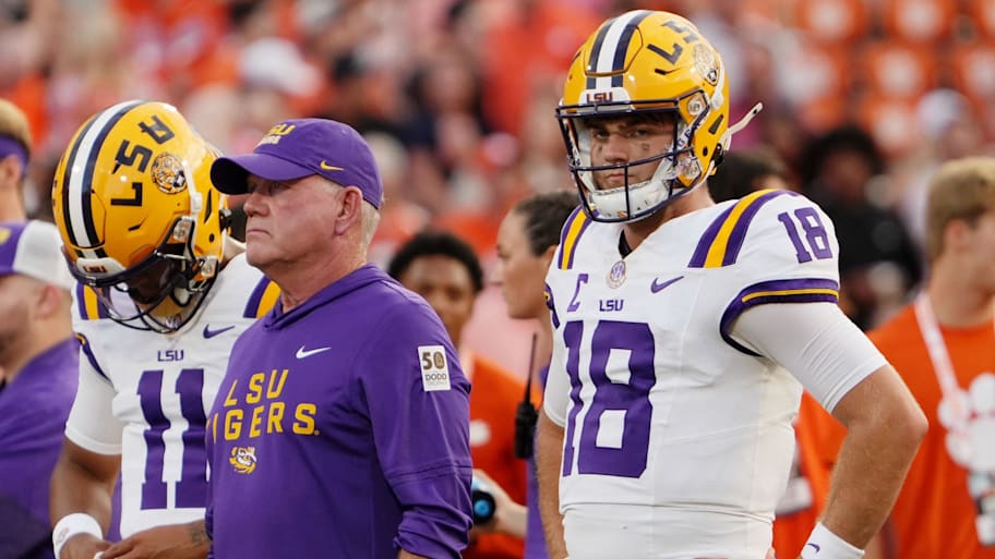 LSU head coach Brian Kelly and quarterback Garrett Nussmeier (18) look on during warmups before the game against Clemson