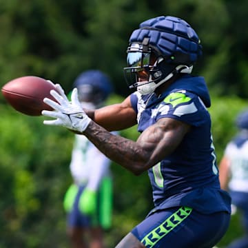 Jul 27, 2024; Renton, WA, USA; Seattle Seahawks wide receiver DK Metcalf (14) catches a pass during training camp at Virginia Mason Athletic Center. Mandatory Credit: Steven Bisig-Imagn Images