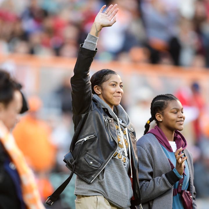Former Lady Vol Candace Parker waves to fans on the field during an SEC football homecoming gam