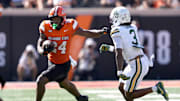 Oklahoma State's Trent Howland (24) rushes Baylor's Devyn Bobby (3) in the first half of the college football game between the Oklahoma State Cowboys and the Baylor Bears at Boone Pickens Stadium in Stillwater, Okla., Saturday, Sept. 27, 2025.