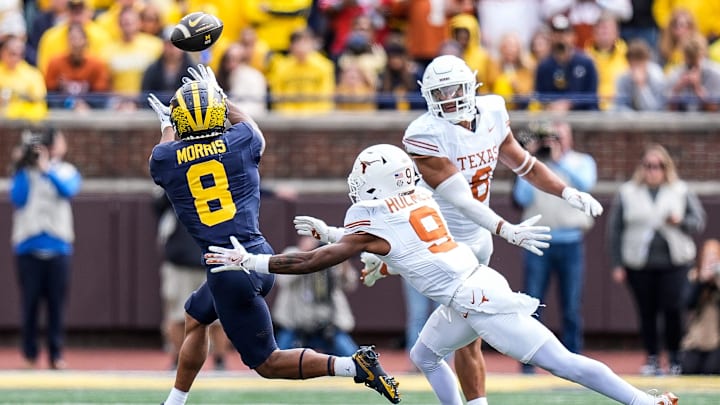 Michigan wide receiver Tyler Morris (8) makes a catch against Texas defensive back Gavin Holmes (9) during the second half at Michigan Stadium in Ann Arbor on Saturday, September 7, 2024.