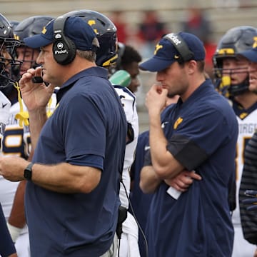 Nov 1, 2025; Houston, Texas, USA; West Virginia Mountaineers head coach Rich Rodriguez talks to wide receiver Cam Vaughn (4) during an official timeout against the Houston Cougars  in the first half at TDECU Stadium.