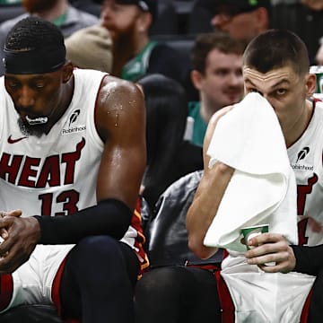 Dec 2, 2024; Boston, Massachusetts, USA; Miami Heat players (left to right) center Bam Adebayo (13), guard Tyler Herro (14), guard Terry Rozier (2) and forward Duncan Robinson (55) sit on the bench during the fourth quarter of their loss to the Boston Celtics at TD Garden. Mandatory Credit: Winslow Townson-Imagn Images