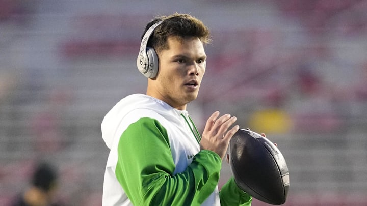 Nov 16, 2024; Madison, Wisconsin, USA; Oregon Ducks quarterback Dillon Gabriel (8) throws a pass during warmups prior to the game against the Wisconsin Badgers at Camp Randall Stadium. Mandatory Credit: Jeff Hanisch-Imagn Images Nov 16, 2024; Madison, Wisconsin, USA; Oregon Ducks quarterback Dillon Gabriel (8) throws a pass during warmups prior to the game against the Wisconsin Badgers at Camp Randall Stadium. Mandatory Credit: Jeff Hanisch-Imagn Images
