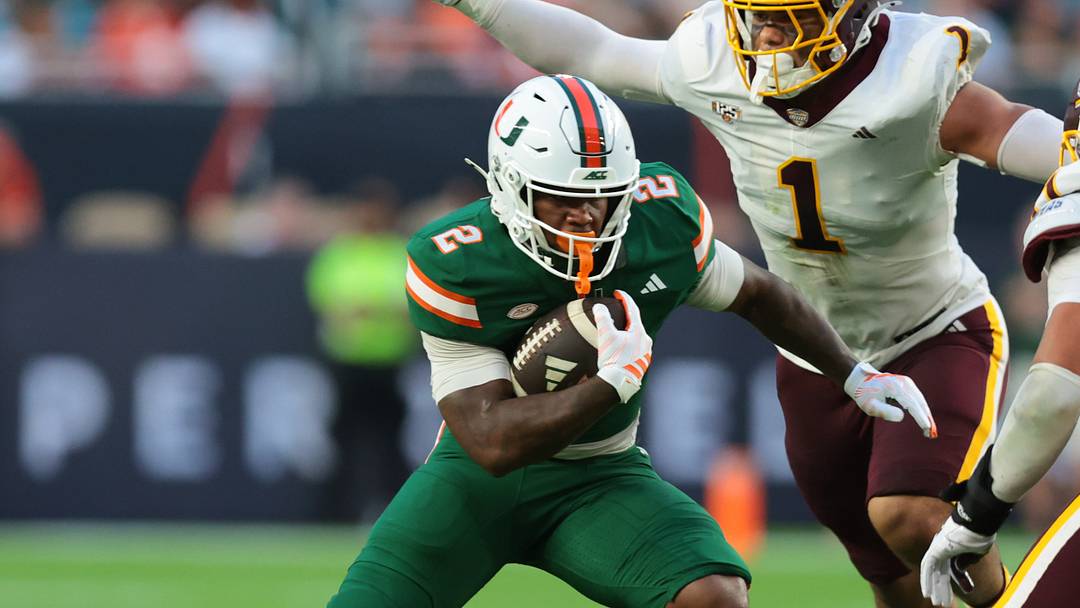 Sep 26, 2026; Miami Gardens, Florida, USA; Miami Hurricanes running back Jordan Lyle (2) runs with the football against Central Michigan Chippewas defensive lineman J.J. Douglas (1) and linebacker Xavier White (11) during the first quarter at Hard Rock Stadium. Mandatory Credit: Sam Navarro-Imagn Images Sep 26, 2026; Miami Gardens, Florida, USA; Miami Hurricanes running back Jordan Lyle (2) runs with the football against Central Michigan Chippewas defensive lineman J.J. Douglas (1) and linebacker Xavier White (11) during the first quarter at Hard Rock Stadium. Mandatory Credit: Sam Navarro-Imagn Images