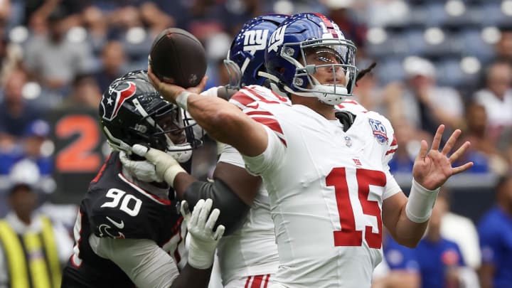 Aug 17, 2024; Houston, Texas, USA;  New York Giants quarterback Tony DeVito (15) passes against Houston Texans defensive end Ali Gaye (90) rush in the fourth quarter at NRG Stadium. Mandatory Credit: Thomas Shea-USA TODAY Sports