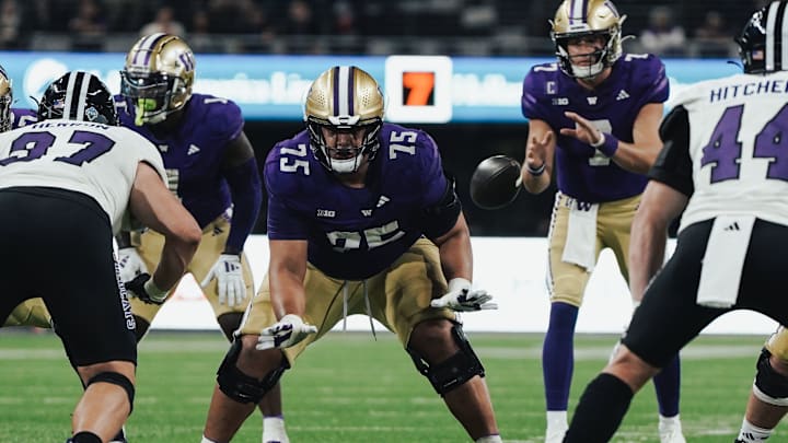 D'Angalo Titialii snaps the ball to Will Rogers against Weber State.