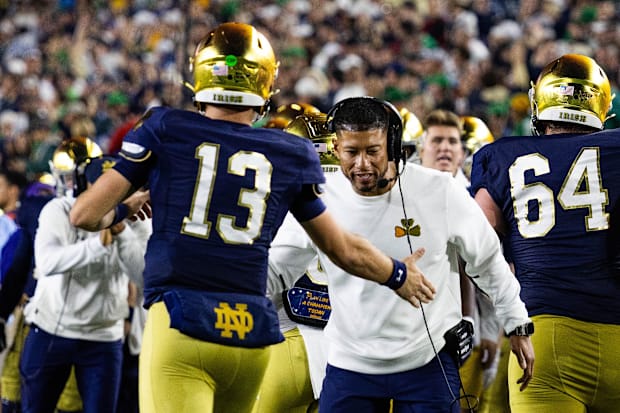 Notre Dame coach Marcus Freeman celebrates with quarterback CJ Carr.