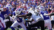 Buffalo Bills running back James Cook runs the ball during first half action of the Bills home game against the New Orleans Saints in Orchard Park on Sept. 28, 2025. Saints Cameron Jordan reaches out to tackle him.