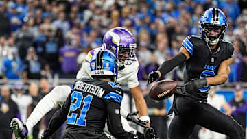 Detroit Lions cornerback Amik Robertson (21), left, and safety Ifeatu Melifonwu (6) break a pass intended for Minnesota Vikings wide receiver Justin Jefferson (18) during the second half at Ford Field in Detroit on Sunday, Jan. 5, 2025.