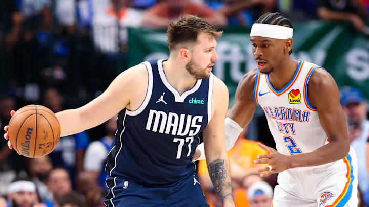 May 11, 2024; Dallas, Texas, USA; Dallas Mavericks guard Luka Doncic (77) controls the ball as Oklahoma City Thunder guard Shai Gilgeous-Alexander (2) defends during the second half during game three of the second round for the 2024 NBA playoffs at American Airlines Center. Mandatory Credit: Kevin Jairaj-Imagn Images