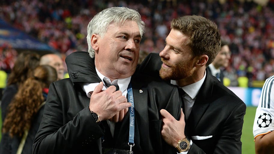 Carlo Ancelotti being embraced by Xabi Alonso after the 2014 Champions League final.
