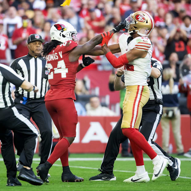Referees throw yellow penalty flags as San Francisco 49ers wide receiver Jauan Jennings (15) fights Arizona Cardinals. Referees throw yellow penalty flags as San Francisco 49ers wide receiver Jauan Jennings (15) fights Arizona Cardinals.