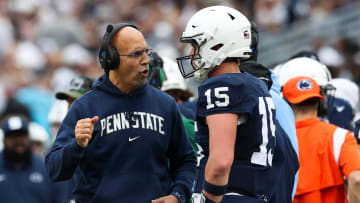 Penn State Nittany Lions head coach James Franklin talks with  quarterback Drew Allar (15)