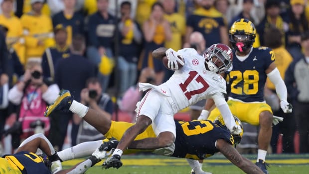 Jan 1, 2024; Pasadena, CA, USA; Alabama Crimson Tide wide receiver Isaiah Bond (17) is tackled by Michigan Wolverines linebac