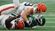 Nov 9, 2025; East Rutherford, New Jersey, USA;  New York Jets quarterback Justin Fields (7) is taken down by Cleveland Browns linebacker Carson Schwesinger (49) in the second half at MetLife Stadium. Mandatory Credit: Robert Deutsch-Imagn Images