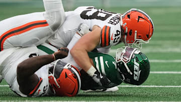 Nov 9, 2025; East Rutherford, New Jersey, USA;  New York Jets quarterback Justin Fields (7) is taken down by Cleveland Browns linebacker Carson Schwesinger (49) in the second half at MetLife Stadium. Mandatory Credit: Robert Deutsch-Imagn Images