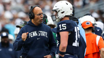 Penn State Nittany Lions head coach James Franklin talks with  quarterback Drew Allar (15) 