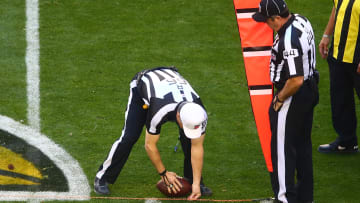 NFL referee Walt Anderson spots the ball after measuring with the chains during a game between the San Francisco 49ers and Arizona Cardinals.