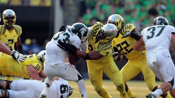 Sep 6, 2014; Eugene, OR, USA; Michigan State Spartans running back Jeremy Langford (33) is tackled by Oregon Ducks defensive lineman Arik Armstead (9) at Autzen Stadium. Mandatory Credit: Scott Olmos-USA TODAY Sports