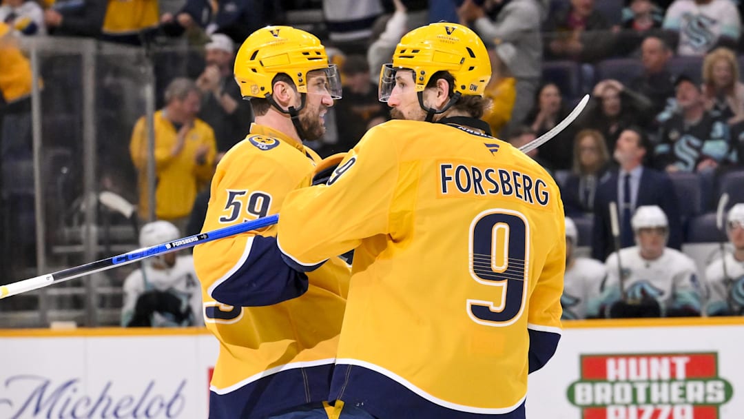 Mar 19, 2026; Nashville, Tennessee, USA;  Nashville Predators left wing Filip Forsberg (9) celebrates with his teammates after scoring a goal against the Seattle Kraken during the third period at Bridgestone Arena. Mandatory Credit: Steve Roberts-Imagn Images