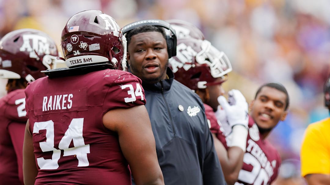 Nov 25, 2023; Baton Rouge, Louisiana, USA;  Texas A&M Aggies interim head coach Elijah Robinson talks to defensive lineman Isaiah Raikes (34) on a time out against the LSU Tigers during the second half at Tiger Stadium. Mandatory Credit: Stephen Lew-Imagn Images