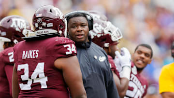 Nov 25, 2023; Baton Rouge, Louisiana, USA;  Texas A&M Aggies interim head coach Elijah Robinson talks to defensive lineman Isaiah Raikes (34) on a time out against the LSU Tigers during the second half at Tiger Stadium. Mandatory Credit: Stephen Lew-Imagn Images
