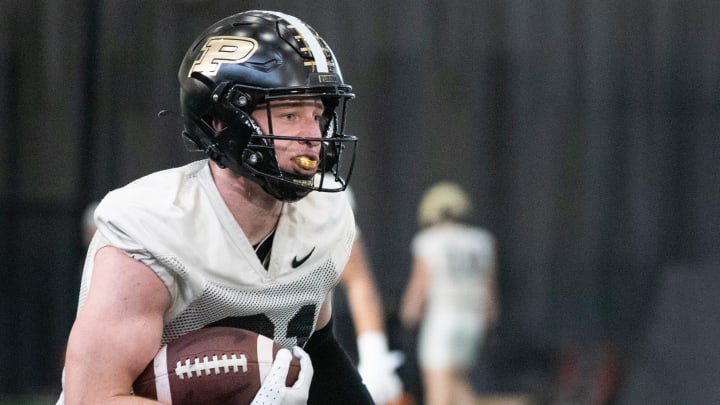 Purdue defensive back Dillon Thieneman runs with the ball during football practice