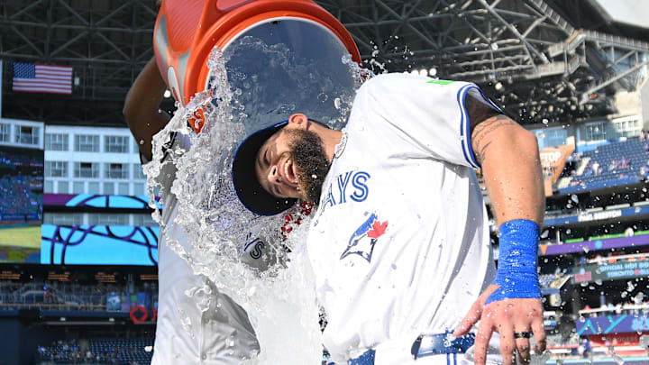 Toronto Blue Jays center fielder Nathan Lukes (38) is doused with ice water by designated hitter Vladimir Guerrero Jr. (27) as they celebrate a win over the St. Louis Cardinals at Rogers Centre on Sept 15.