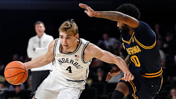 Vanderbilt's  Grant Huffman drives by Cal's Jovan Blacksher Jr. 
