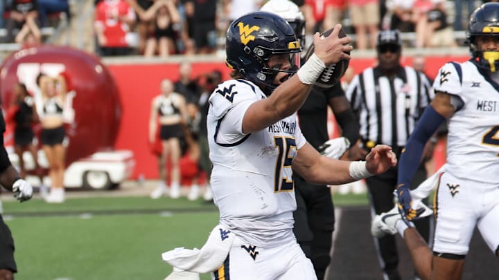 Nov 1, 2025; Houston, Texas, USA; West Virginia Mountaineers quarterback Scotty Fox Jr. (15) rushes for a touchdown against the Houston Cougars in the second half at TDECU Stadium. Mandatory Credit: Thomas Shea-Imagn Images