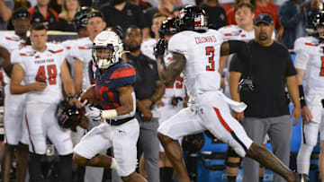 Sep 14, 2019; Tucson, AZ, USA; Arizona Wildcats running back Darrius Smith (20) runs the ball under pressure from Texas Tech Red Raiders defensive back Douglas Coleman III (3) during the second half at Arizona Stadium. Mandatory Credit: Casey Sapio-Imagn Images