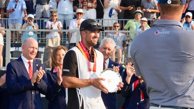 Greg Bodine receives champions' caddie plate after Bryson DeChambeau captures US Open at Pinehurst No. 2 in North Carolina.